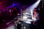 This image shows drummer Jon Finnigan performinbg with The All New Blues and Soul Revue at Dartmouth Regatta.