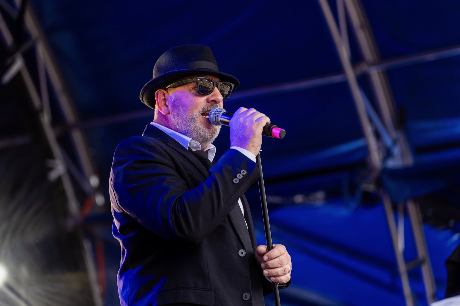 Dave Wiggins performing as Jake, singing into a microphone at FeastyFest 2026
