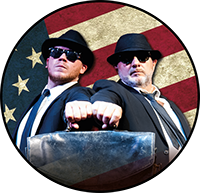The All New Blues and Soul Revue logo. Jake and Elwood in black suits, hats and shades against a circular US flag.